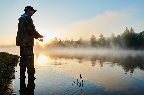 Man Fishing At Sunrise