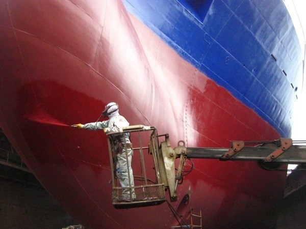 Painting the ship with antifouling paint.